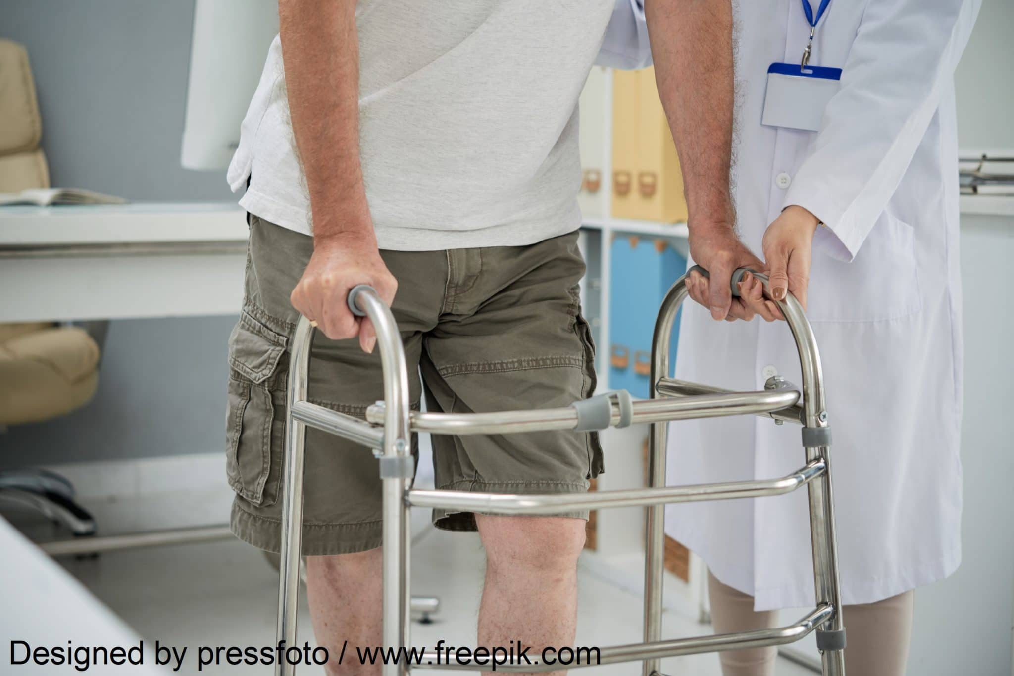 Man making first steps with help of walker after rehabilitation therapy