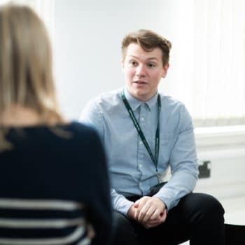 Social worker talking to a colleague