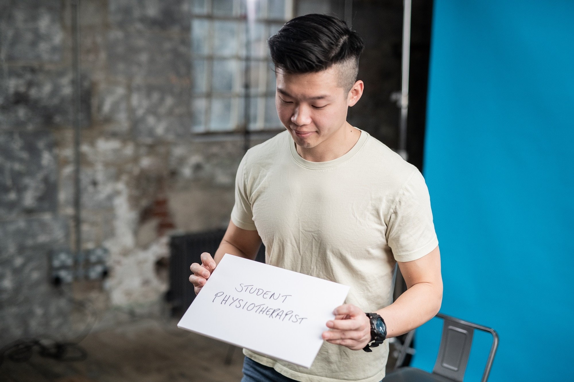 Student physiotherapist holding a name card