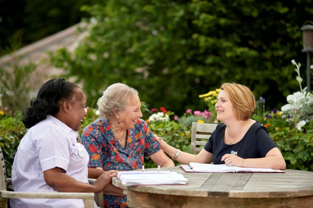Three people in a garden