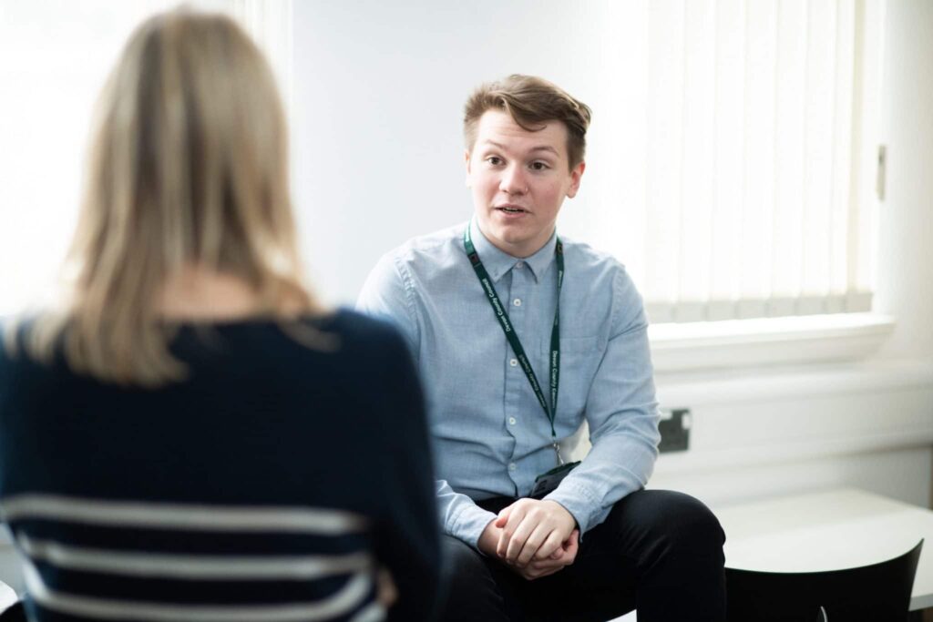 Social worker talking to a colleague