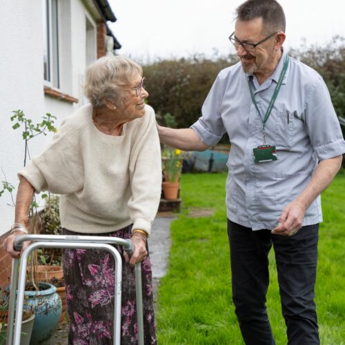 Lady with zimmer frame in garden with reablement worker