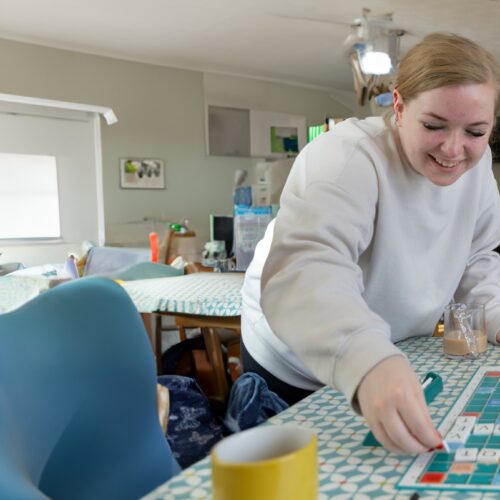 Care worker and older lady playing scrabble