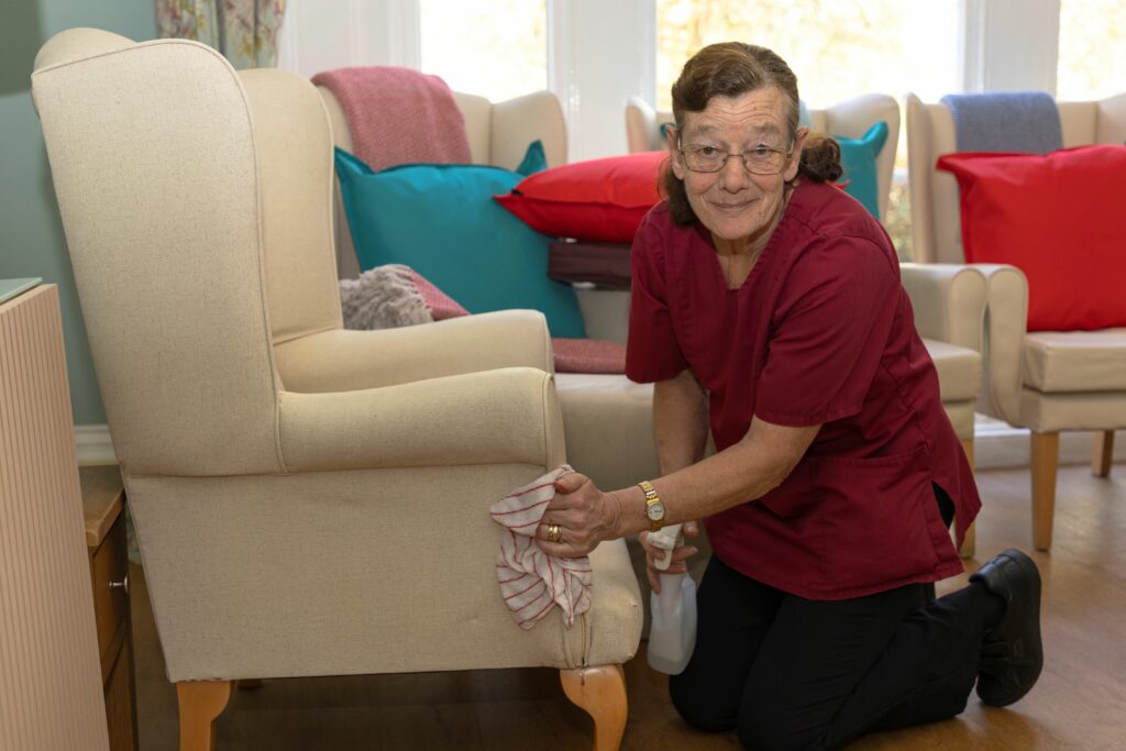 A housekeeper cleaning a chair