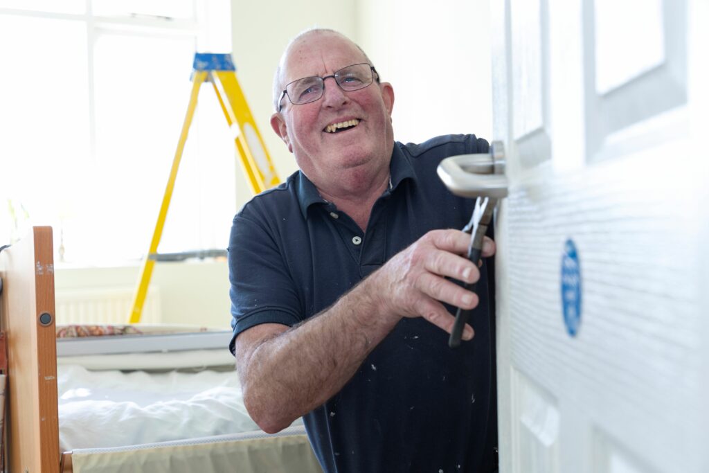 A man fixing a door