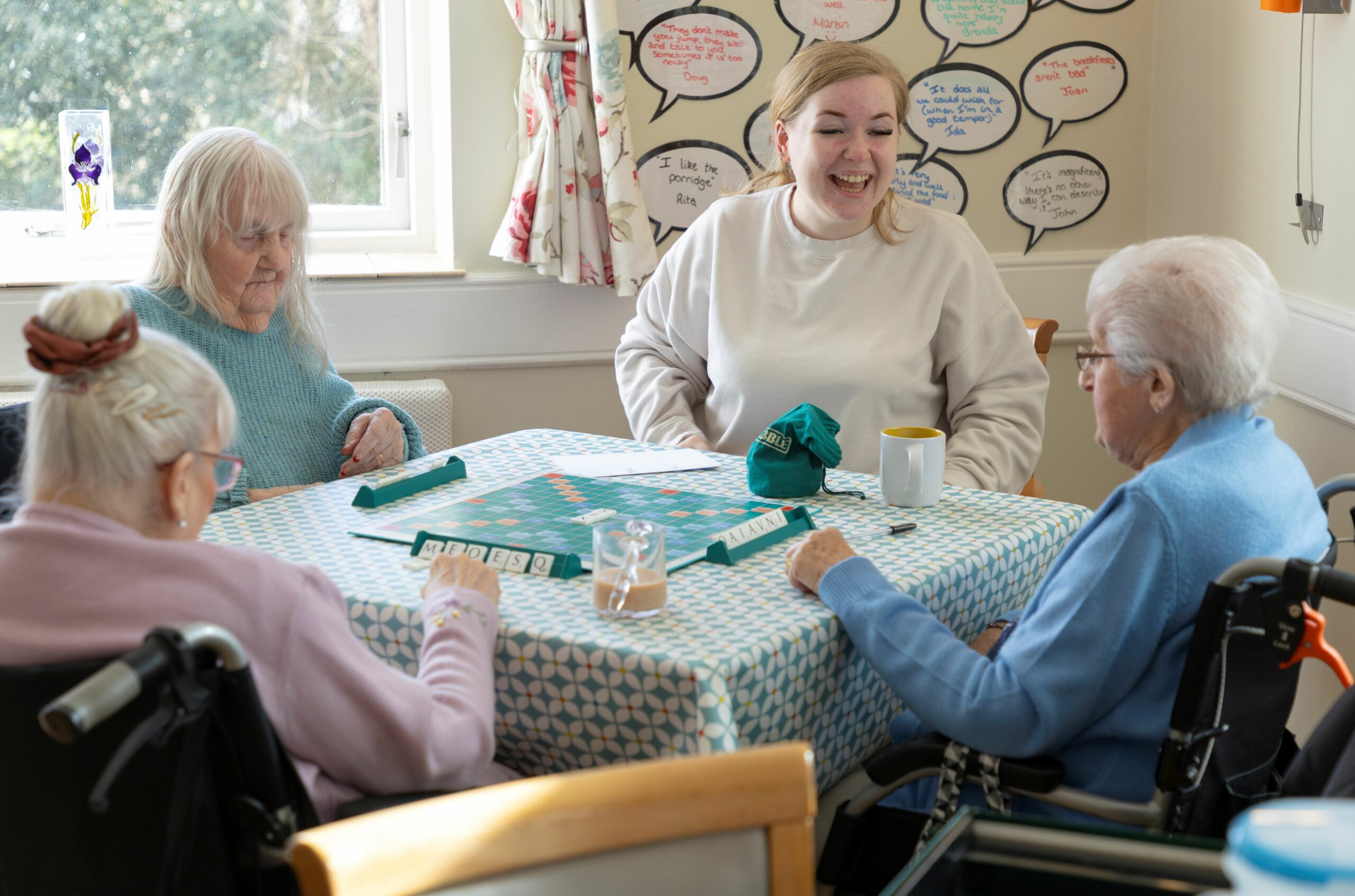 Four people playing scrabble