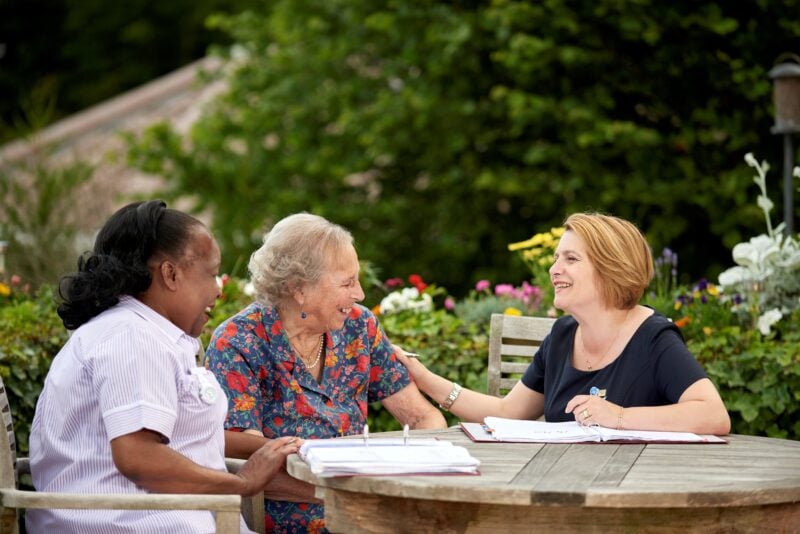 Three people in a garden
