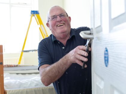 A man fixing a door