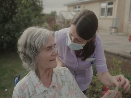 A older women in a wheelchair with a carer